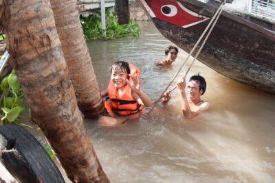 From HCM city: Private Mekong Delta - Ben Tre Full-Day Tour - Ben Tre by river: boat views with coconut shade and working waterways