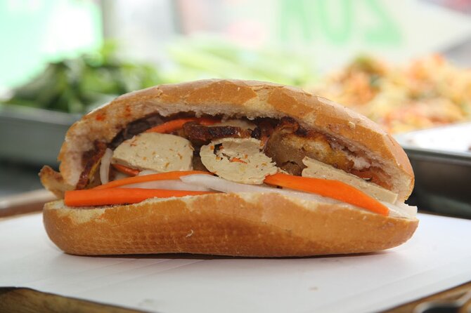 The Coolest Vegan Food Tour by Motorbike in Ho Chi Minh City - Stop 2: Vietnam-era box apartments and vegan bún bò Huế